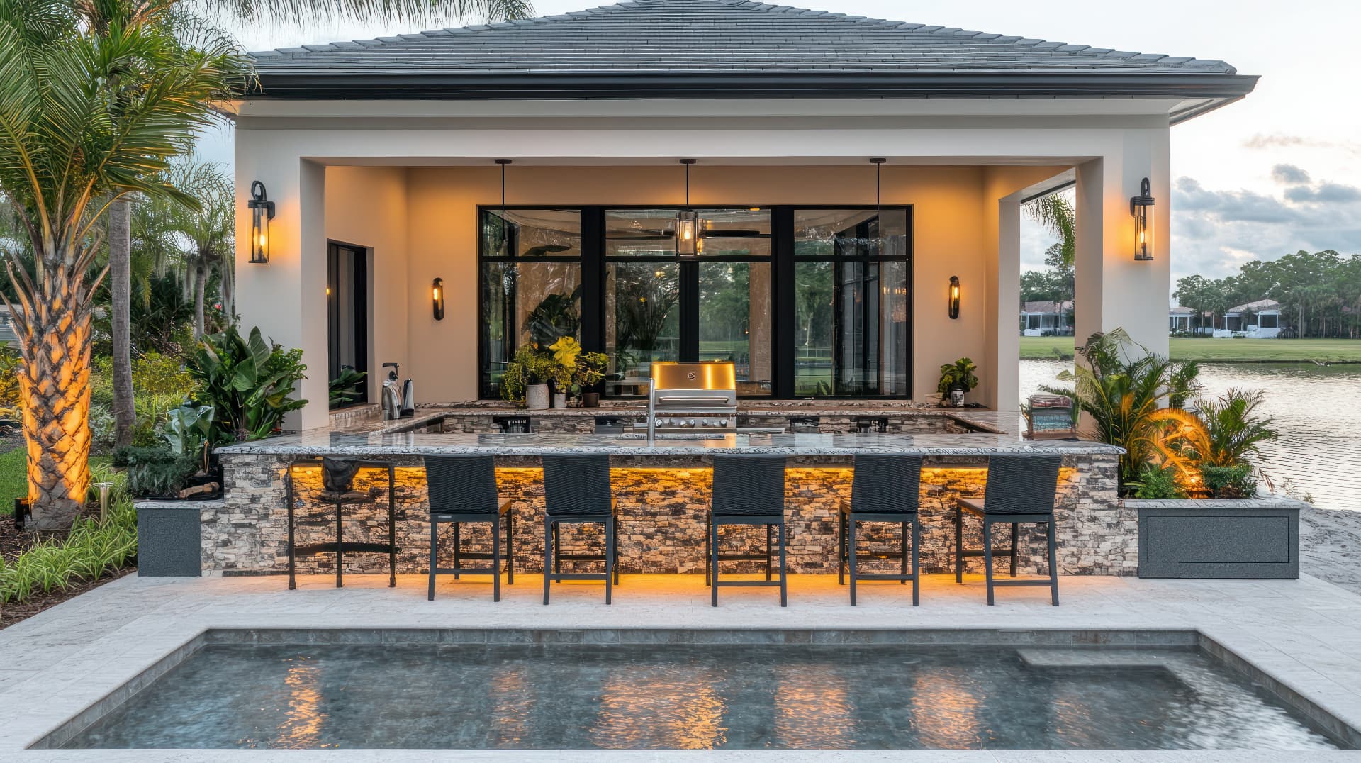 Luxury outdoor kitchen with poolside bar and seating