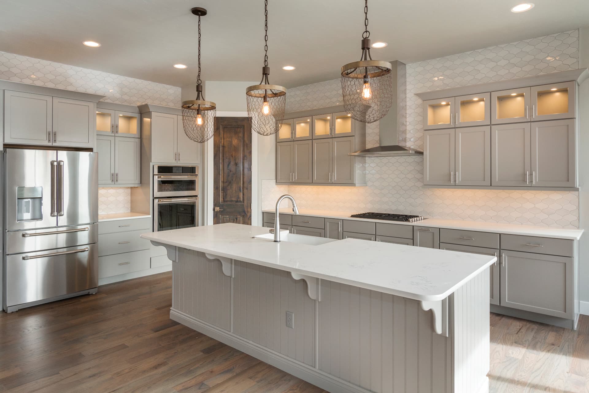 Contemporary kitchen with gray cabinets and pendant lighting