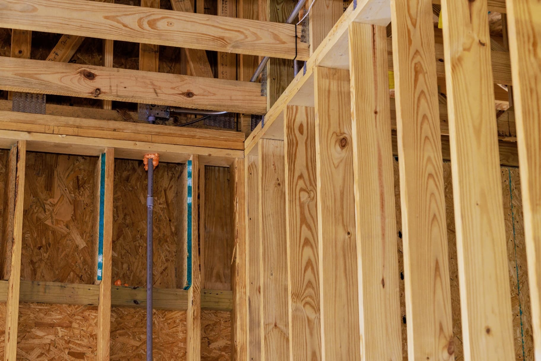 Wood stud framing and structural support beams in construction