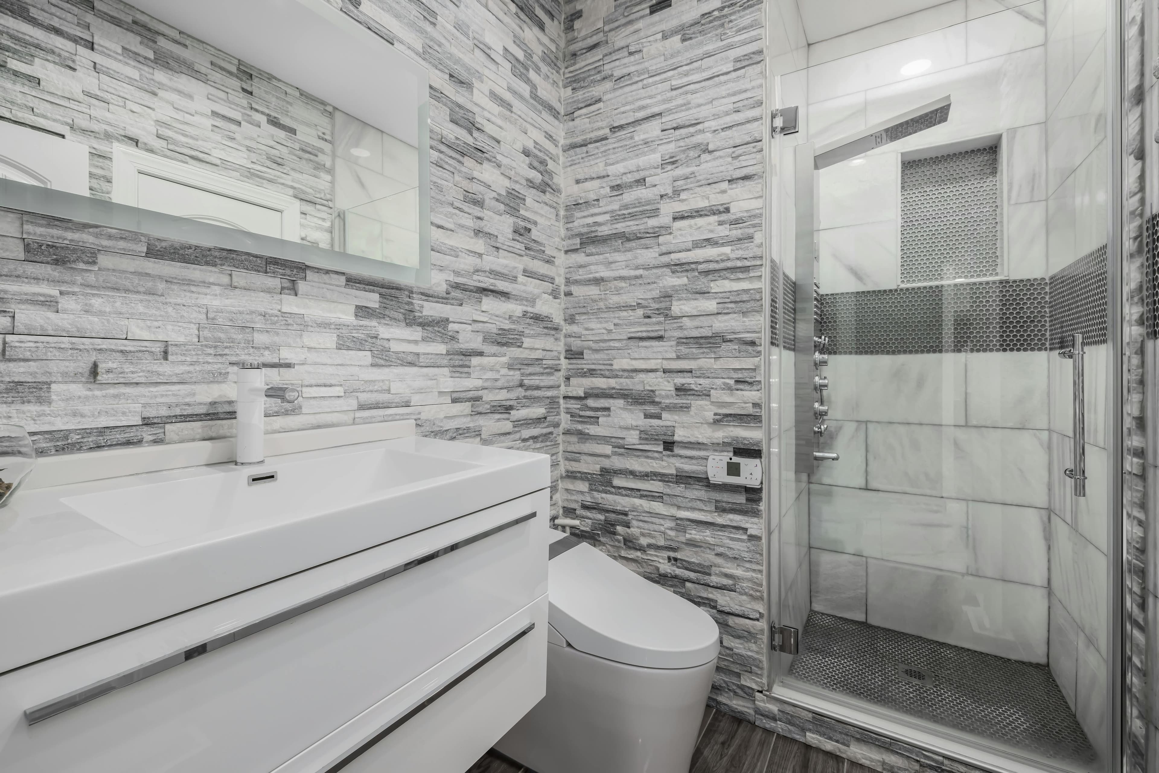 Modern budget bathroom remodel under $10,000 with white tile
