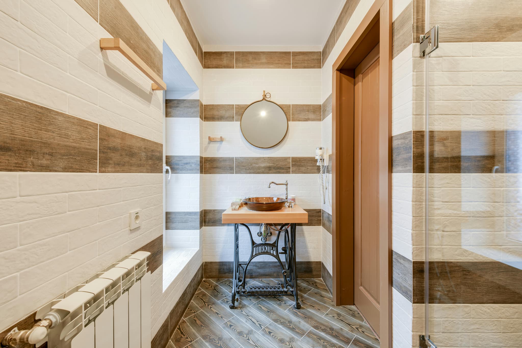 Vinyl plank flooring and brushed nickel fixtures in bathroom