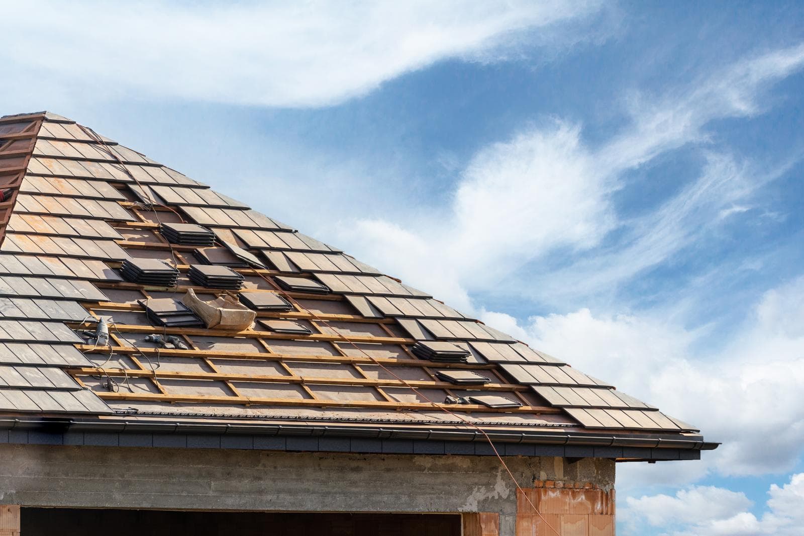 New roof construction with shingles being installed